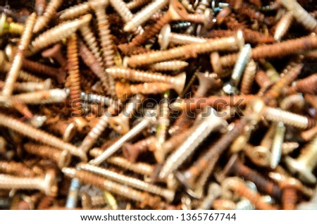 Blurry rusty brown, white and orange nails. A group of old and blurry rusty nails. 