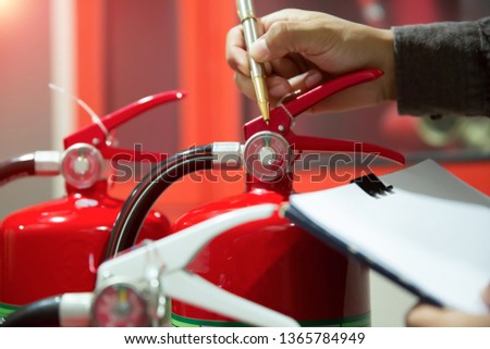 Engineers are checking fire extinguishers.