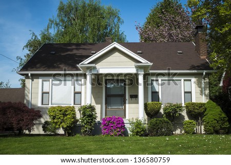 Single-family American craftsman house with blue sky background Royalty-Free Stock Photo #136580759
