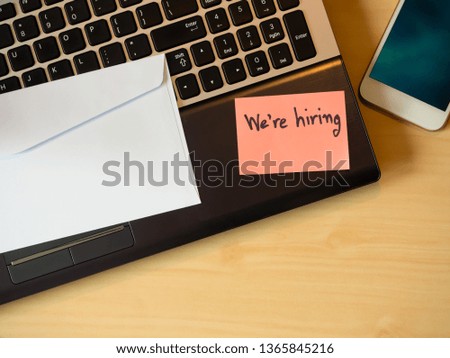 We are hiring to be message in the letter  on the table. Top view for background. Business concept.