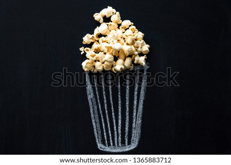 pop corn bucket on a blackboard