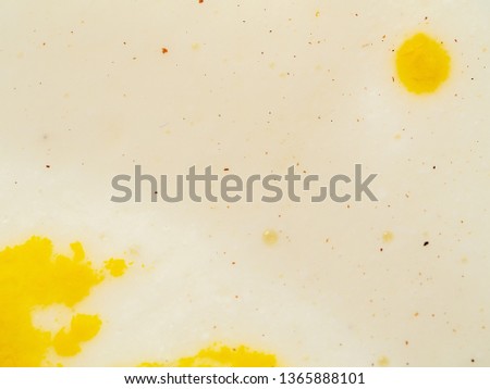 Yellow spots on abstract bright background. Close up macro shot. Blurred background. Spots of yellow paint on white background. Abstract pattern of points and spots