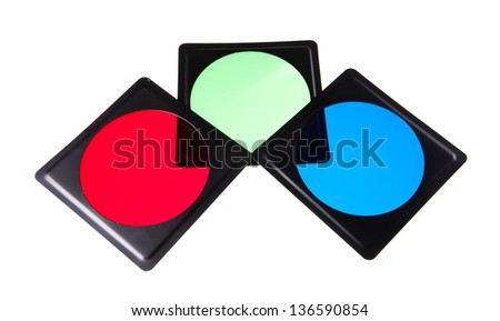 Three plastic light modifiers filters in rgb colors, red, blue and green objects in horizontal orientation, isolated on white, nobody in studio shot.