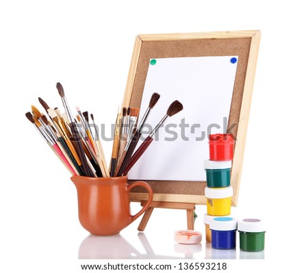 Small easel with sheet of paper and art supplies isolated on white