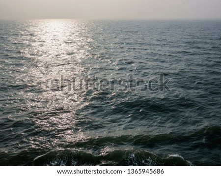 Wind and waves, dark clouds, and boat sights on the sea captured on a cruise ship