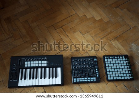 Electronic synthesizers isolated on wood background with clipping path.