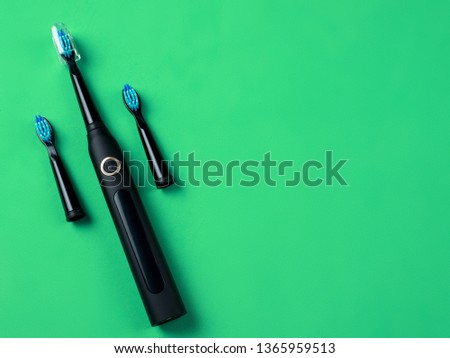 Modern electric sonic brush on color background with copyspace