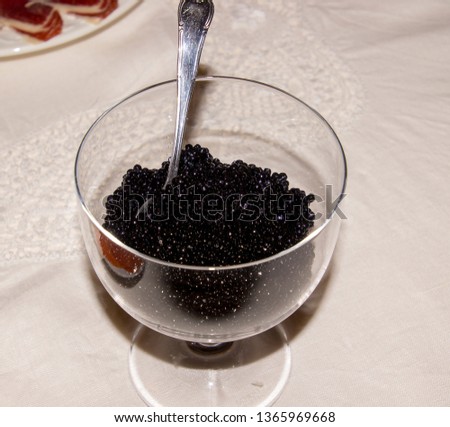 Glass jar with black caviar