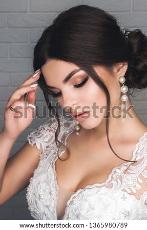 Portrait of beautiful modest shy and very cute girl with brown hair and light eyes in Studio, close-up Royalty-Free Stock Photo #1365980789