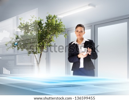 Image of young female ecologist holding cup standing against high-tech picture