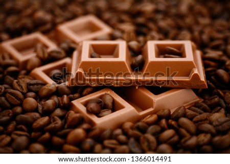 Pieces of milk chocolate with coffee beans