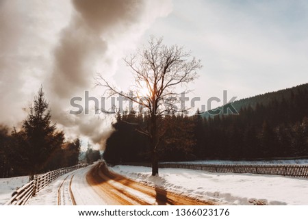 A photo of winter road of handsome village in mountain