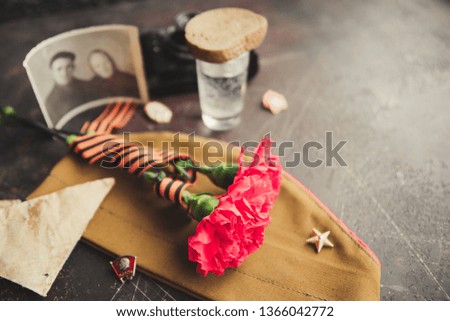 background for postcards by may 9, victory day: cap, letters, carnations and St. George ribbon