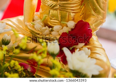 Sprinkle water onto a Buddha Statue.  setting up in Songkran festival 