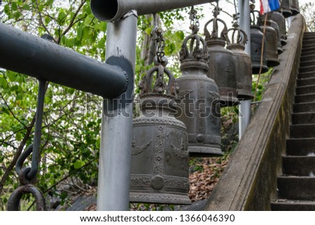Alloy bell on the stairway in asian temple 