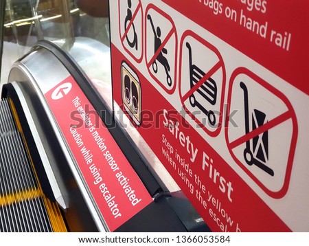 Signs on an escalator, warning signs, the escalator at the shopping mall