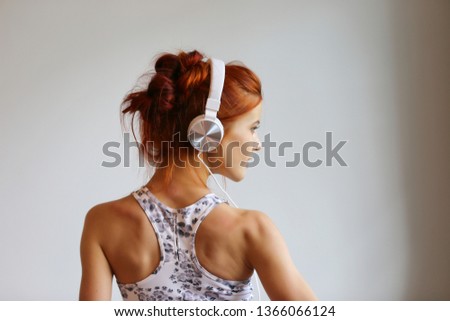 Head shot portrait of trendy gorgeous cute girl with natural makeup not looking at  camera isolated on grey background having caucasian nationality 