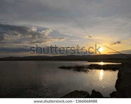 Fishing on the lake at sunset