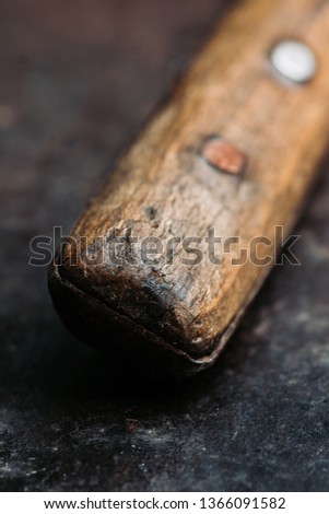 Old rustic handmade knife on the rustic background. Selective focus. Shallow depth of field.