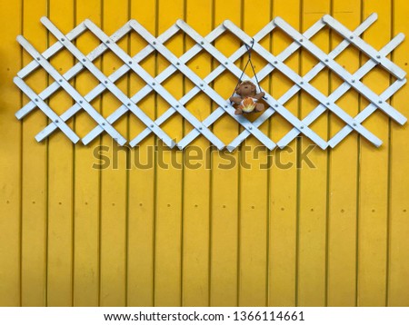 Yellow color wood wall background with white bamboo weave. wallpaper to decorate in the house. 
