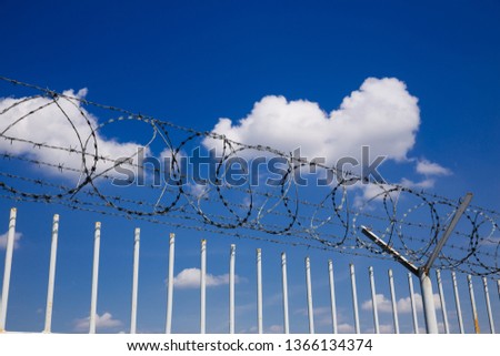 Barbed wire fence. Immigration themed image. 