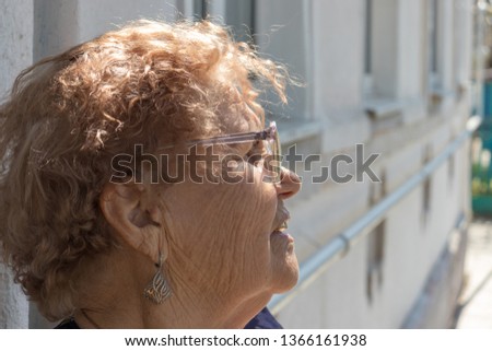 
Elderly woman looks into the distance
