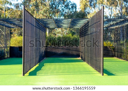 A cricket practice net on green grass in Melbourne, Victoria, Australia Royalty-Free Stock Photo #1366195559