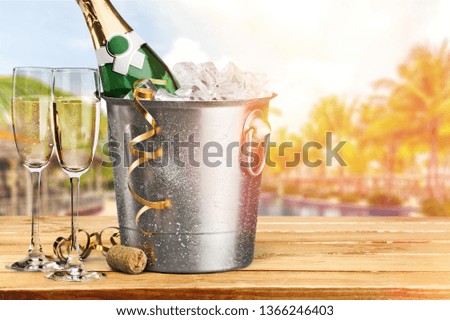 Two glasses of champagne and bottle on background