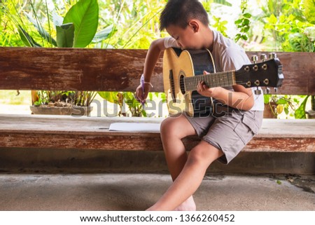 Boy intends to play classical guitar