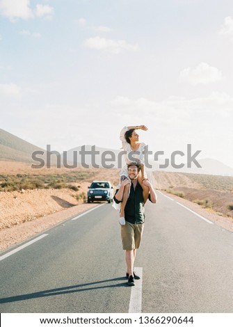 Young happy lovers having fun on the road. Couple making a wanderlust vacation, exploring Morocco with their sport utility vehicle car. Royalty-Free Stock Photo #1366290644