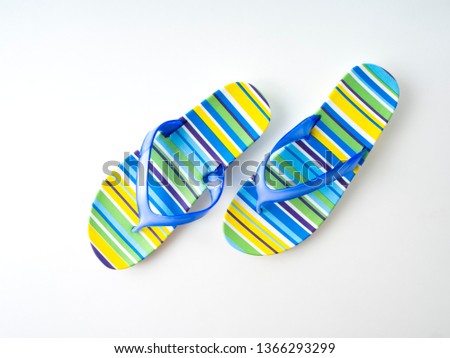 New fashion slippers for woman. Beautifu Colorful striped flip flops on white background. . Summer holiday concept.