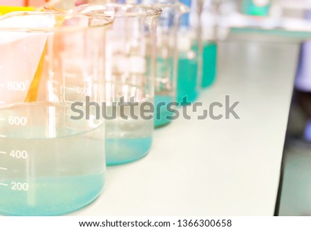 Waste water sample in beakers coagulation and flocculation method with Copper Sulfate and using Jar test for forming precipitation and reduced turbidity calibration range. Use for science background. Royalty-Free Stock Photo #1366300658