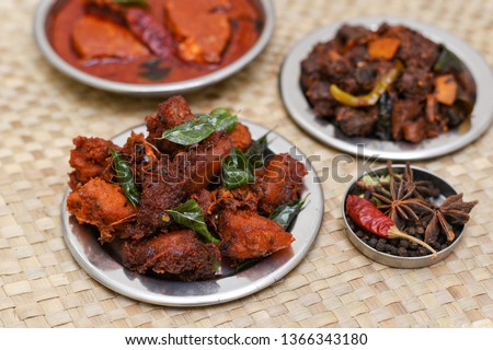 Chicken 65, beef roast, fish curry hot and spicy side dishes of rice, chapati Kerala, South India. Non vegetarian starter or quick snack. Popular and traditional recipe prepared using Indian spices. 