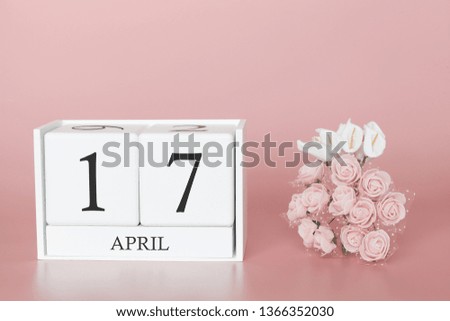 April 17th. Day 17 of month. Calendar cube on modern pink background, concept of bussines and an importent event.
