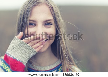 portrait of a beautiful happy smiling girl outdoors in spring