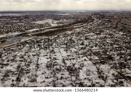 Top view of winter city landscape with tall buildings. Drone aerial photography.