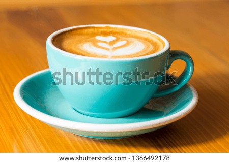 Hot Mocha - A Cup of Coffee with Beautiful Latte Art on wooden table background, Morning Breakfast
