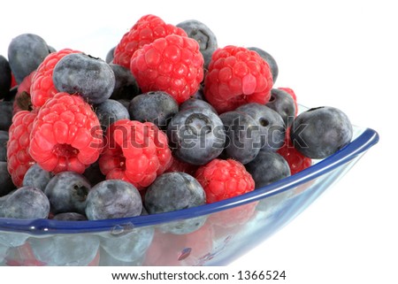 Raspberries and blueberries in a glass bowl. Royalty-Free Stock Photo #1366524