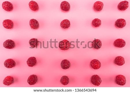 Pattern made from fresh raspberries, top view, flat lay pattern, isolated on a light pink background.
