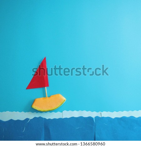 Melon slice sailing in the ocean making from paper.
