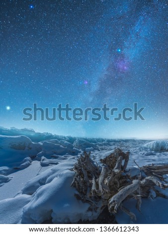 Beautiful night landscape, frozen lake at the night. Milky way galaxy. Sevan lake, Armenia. 
