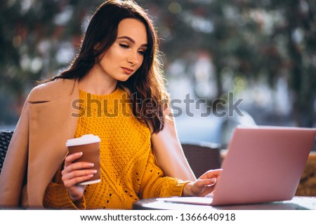 Business woman working on a computer and drinking coffee