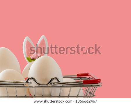 White eggs and rabbit in the basket. Easter holiday decorations , Easter concept background.