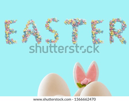 White eggs and rabbit on blue background. Easter holiday decorations , Easter concept background.