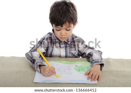 Little boy is drawing with pencil his family