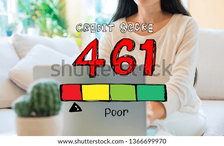 Poor credit score theme with woman using her laptop in her home office