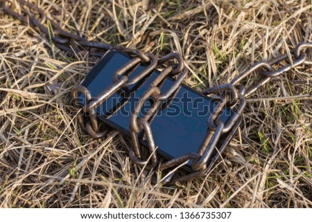 Chained telephone on the grass.