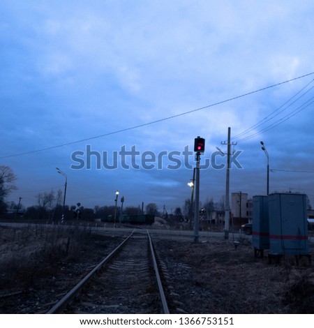 Railroad rails at a road crossing in the evening. Railroad rails.