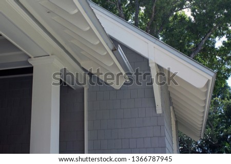 Deep overhangs on gable ends of house provide protection from sun and deflect rain from walls. 