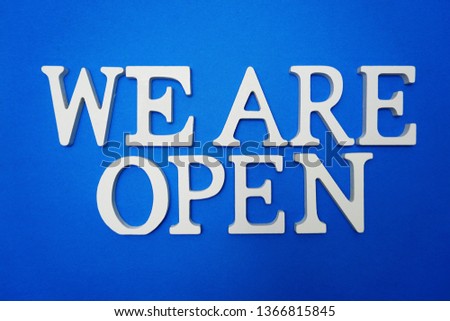 We are Open alphabet letters on blue background